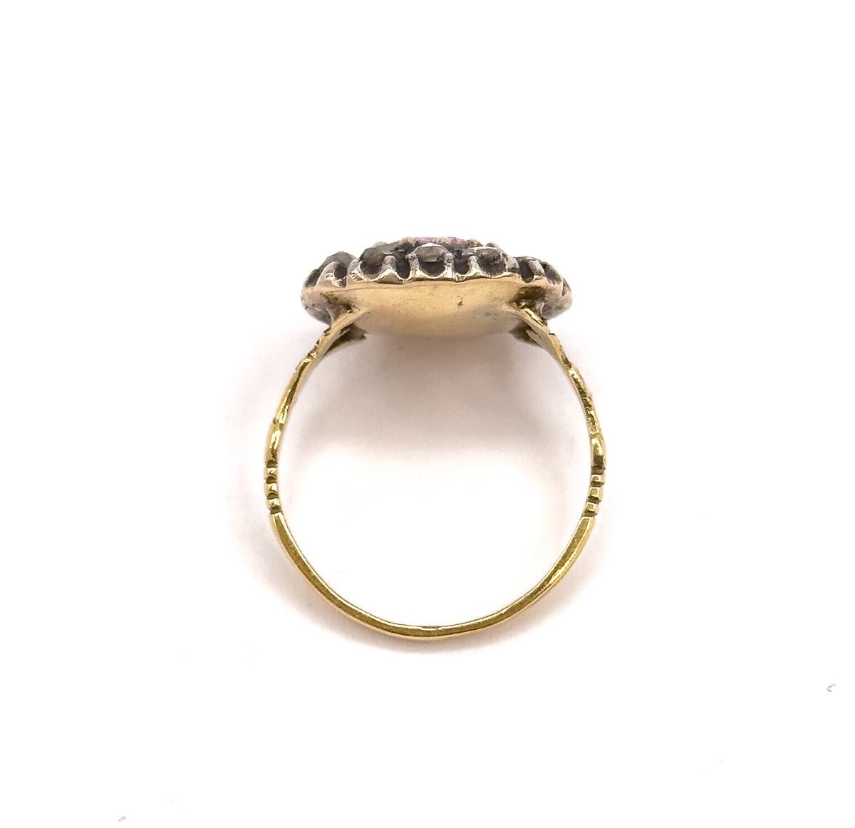 Viewed from behind and above, the closed-back gold underside of the face fills the centre, the diamond halo rising beyond it and the fine shank forming a full circle below.