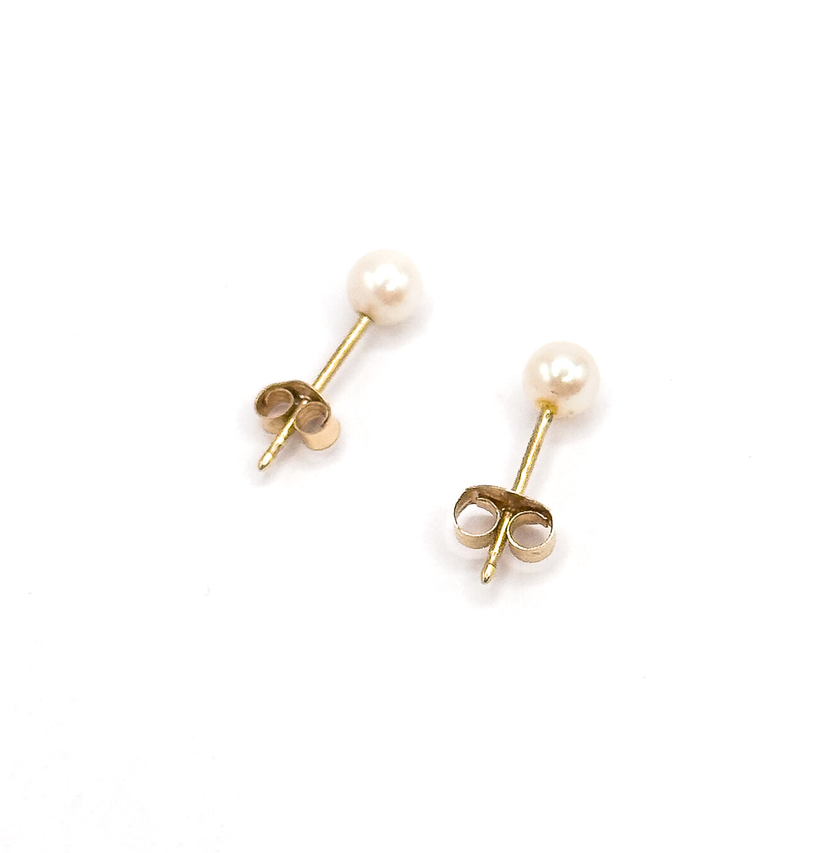 A pair of pearl stud earrings in 14 karat yellow gold, shown side by side on a white background with posts and butterfly backs angled toward the viewer.