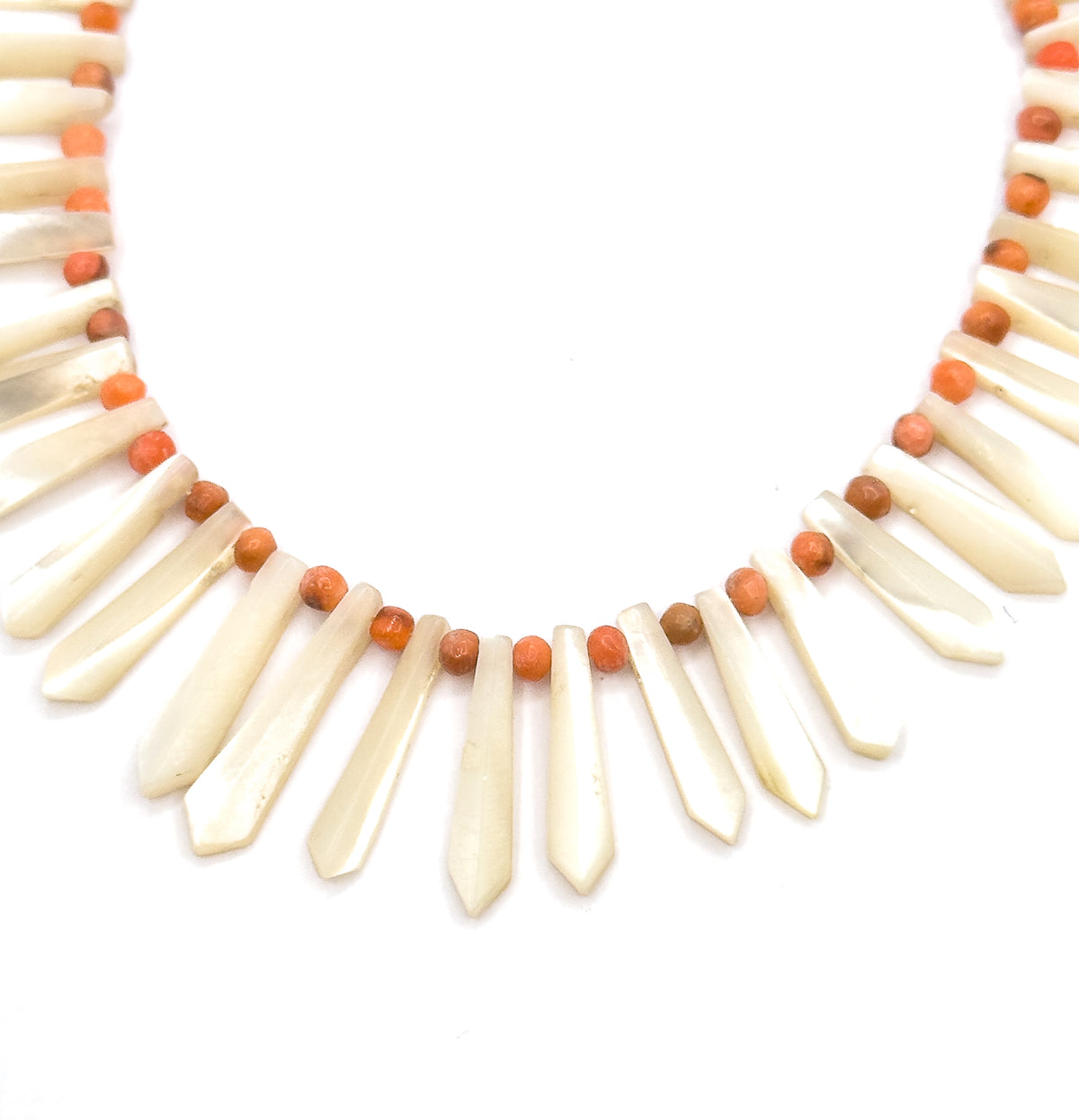 Laid flat on a plain white background, this crop isolates the front curve alone, so the pickets can be seen shortening evenly from the centre outward with a coral bead in each gap.