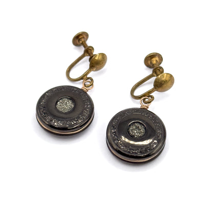 Seen from above with the pair set diagonally, the rounded oval screw pads and their threaded shafts stand out clearly above each disc, and the rose gold filled wire can be traced around the rim.