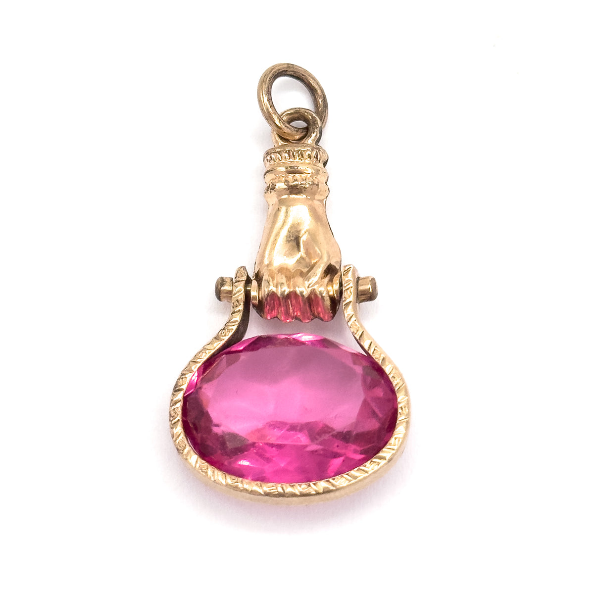 Straight-on front view against white, the suspension ring, ribbed cuff and rosy yellow hand centred above the oval pink glass, which sits fully upright in its engraved bezel between the pivot lugs.