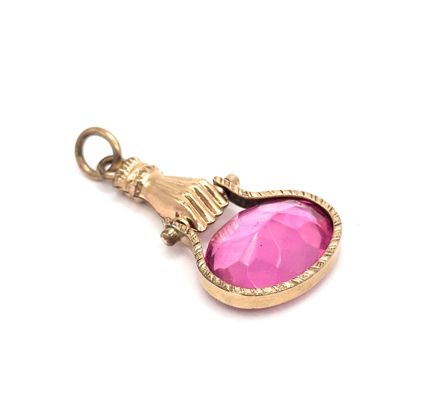 Three-quarter tilted view on white showing the depth of the bezel's smooth back rim beneath the faceted pink glass, with the cuff, pivot lugs and open suspension ring rising behind.