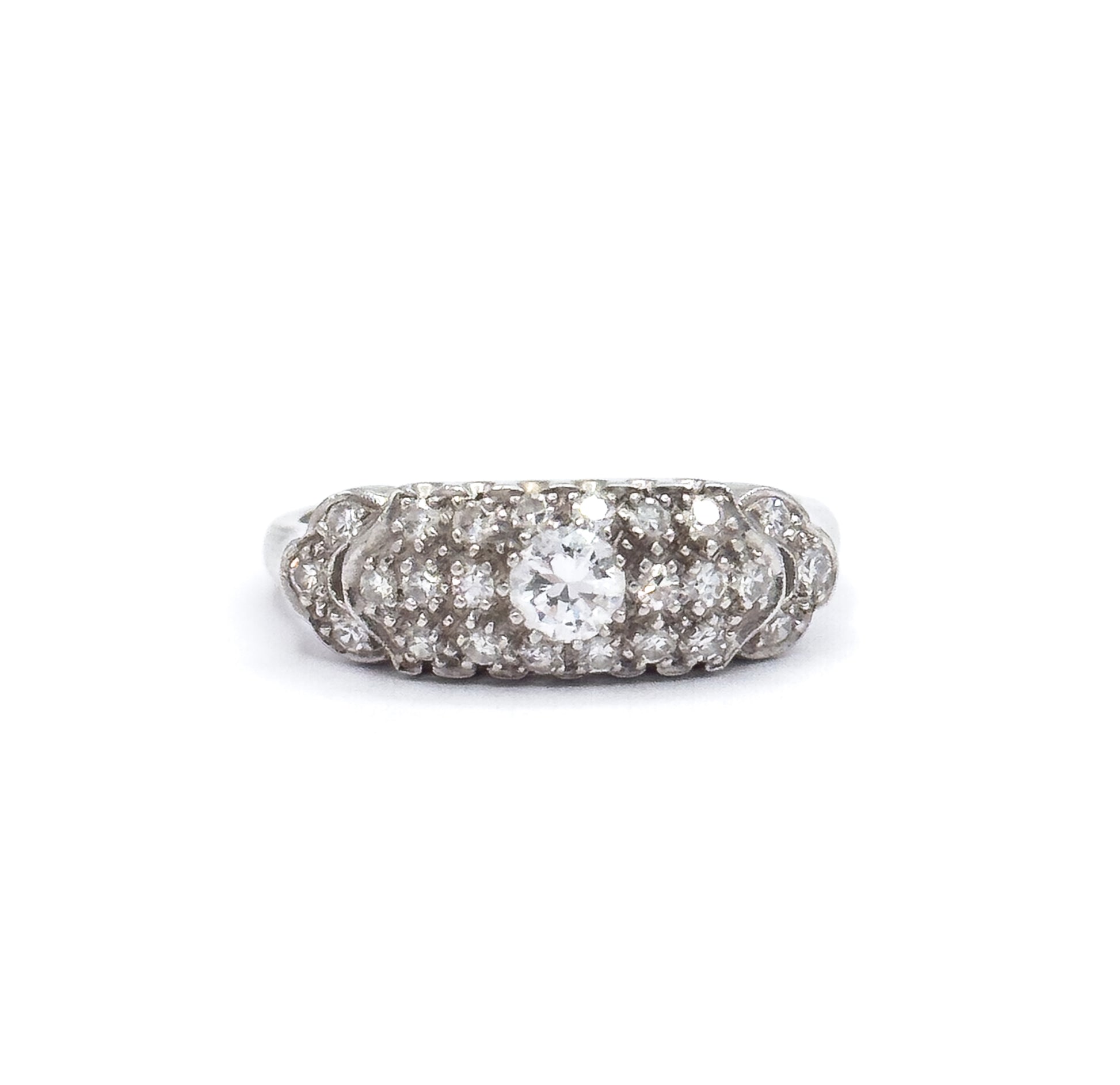 Overhead view against white showing the whole scalloped pavé face from above, the transitional cut centre diamond ringed by single cut diamonds with the platinum shank dropping away at each side.