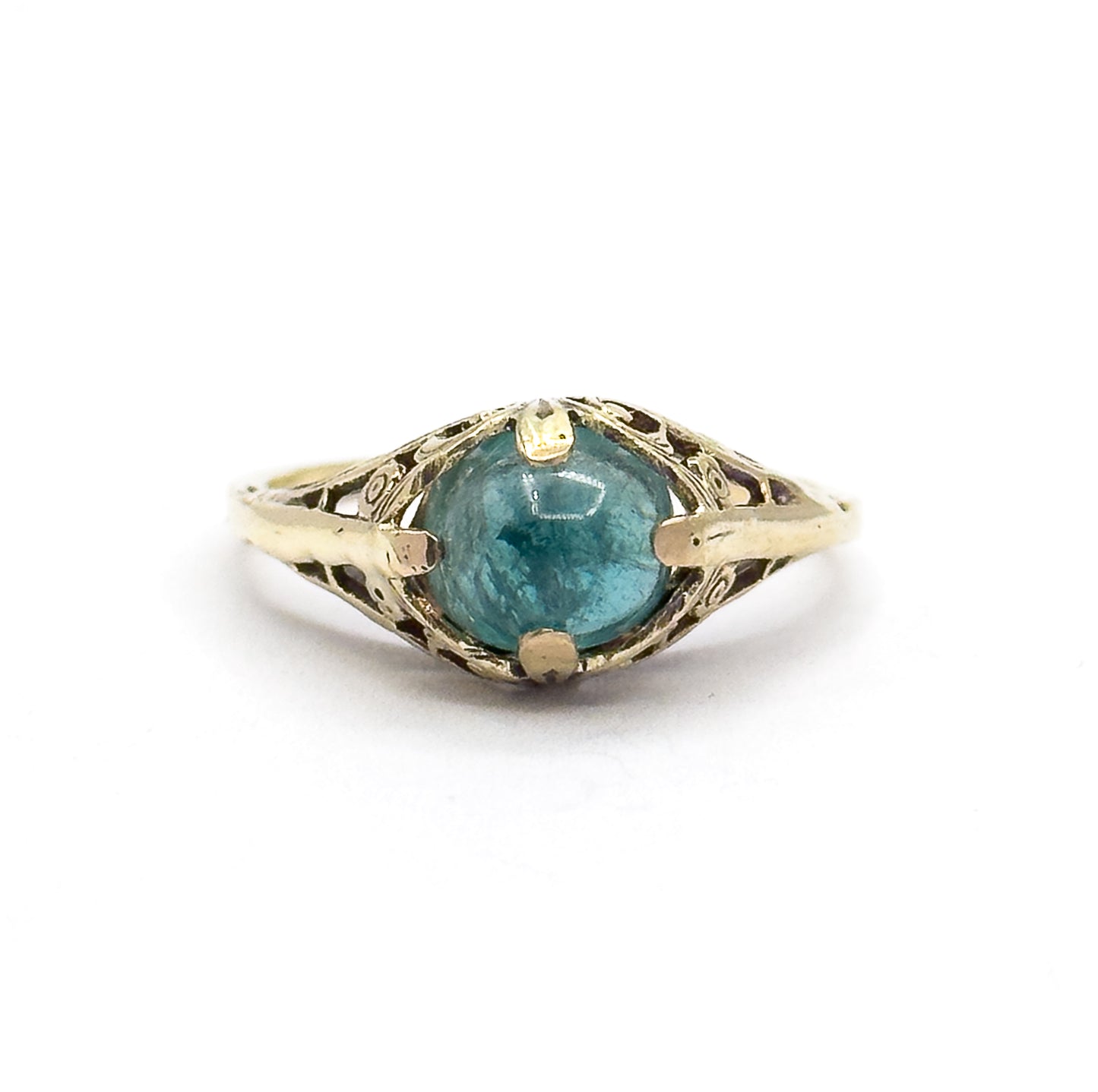 Straight-on view from directly above the ring lying flat, the round greenish blue cabochon centred between four prongs with the pierced fern gallery spreading symmetrically to each shoulder.