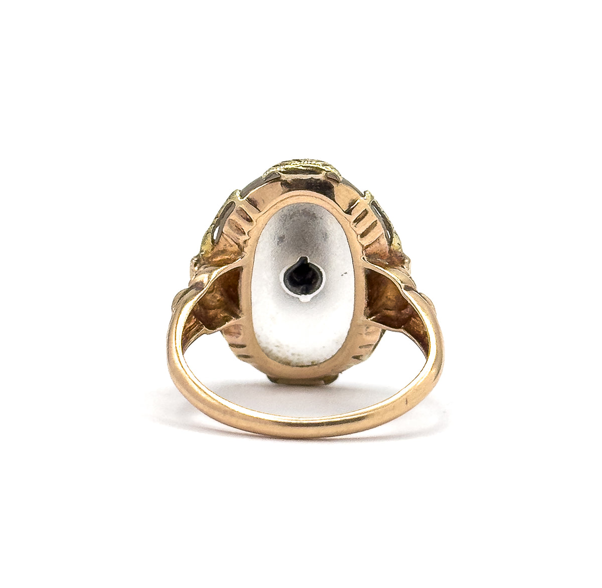 Almost the same view with slightly different angle, looking straight into the back of the setting where the flat underside of the cabochon shows the dark point of the diamond's setting at its centre.