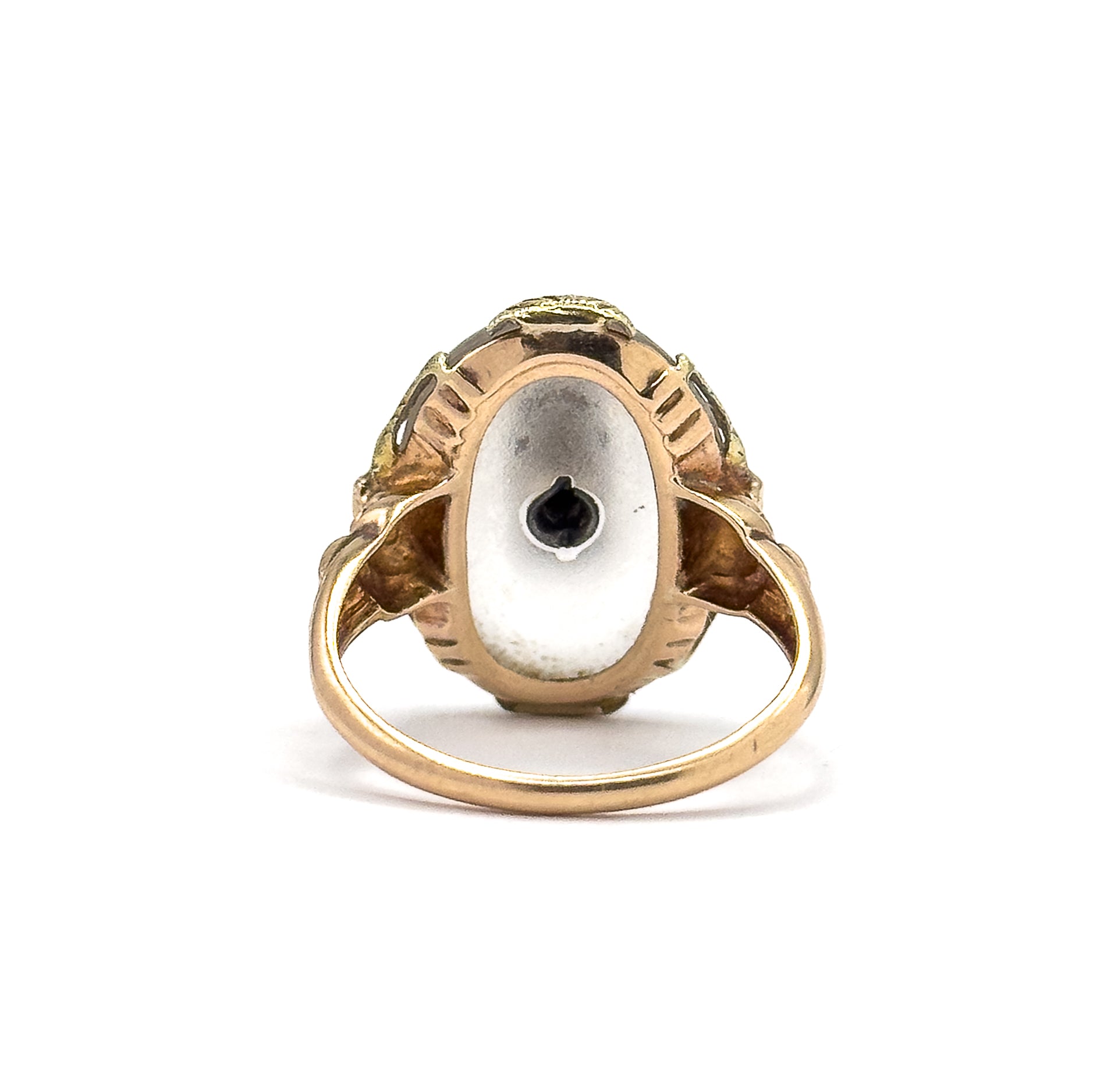 Almost the same view with slightly different angle, looking straight into the back of the setting where the flat underside of the cabochon shows the dark point of the diamond's setting at its centre.