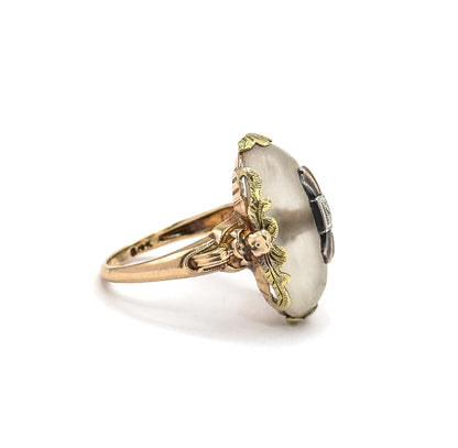 Profile from the opposite side, close enough to show the small gold flower where the leaf gallery meets the ribbed shoulder, and the height the dome stands above the shank.