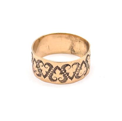 Viewed straight on at eye level, the linked hearts and dotted scrolls face the viewer squarely while the plain inner wall of the shank shows through the opening above.