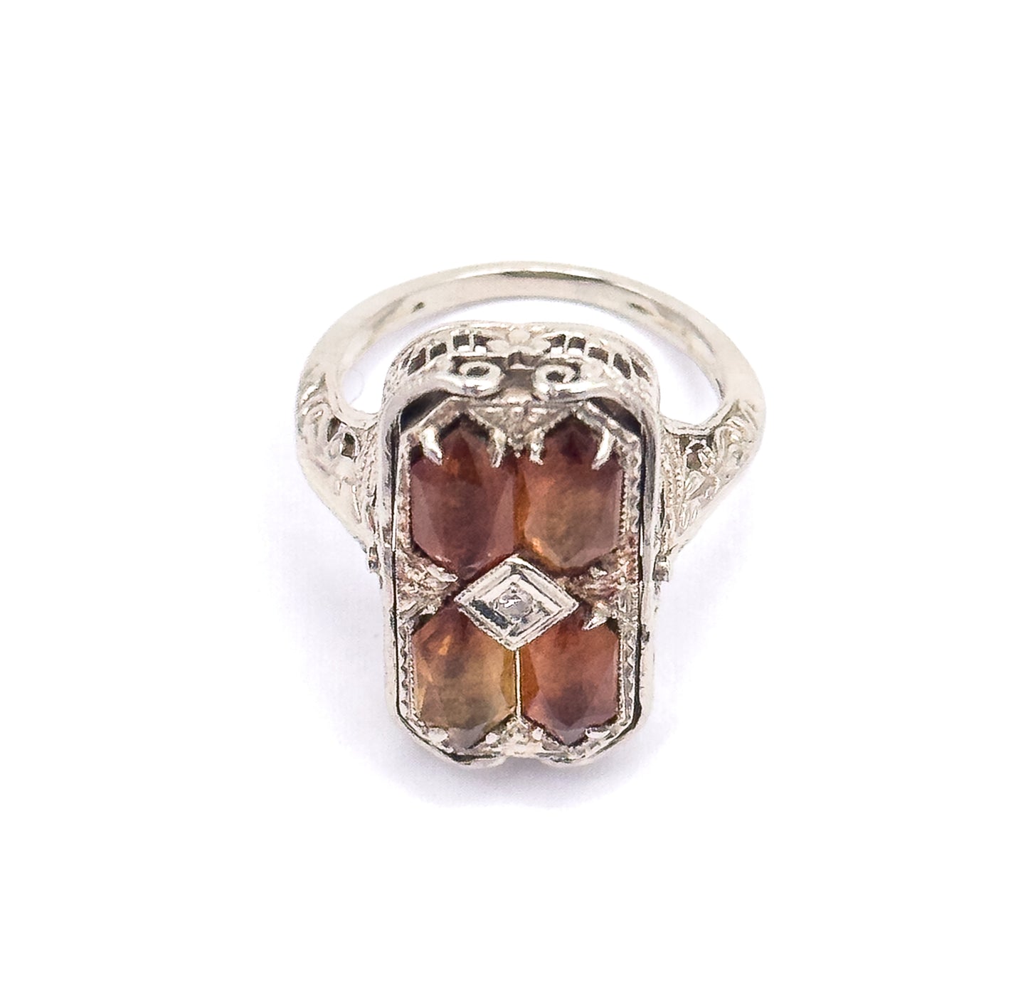 Straight-on view of the citrine side, showing the pierced scrollwork across the top of the gallery, the diamond-shaped centre setting, and the engraved shoulders flowing into the slim shank.