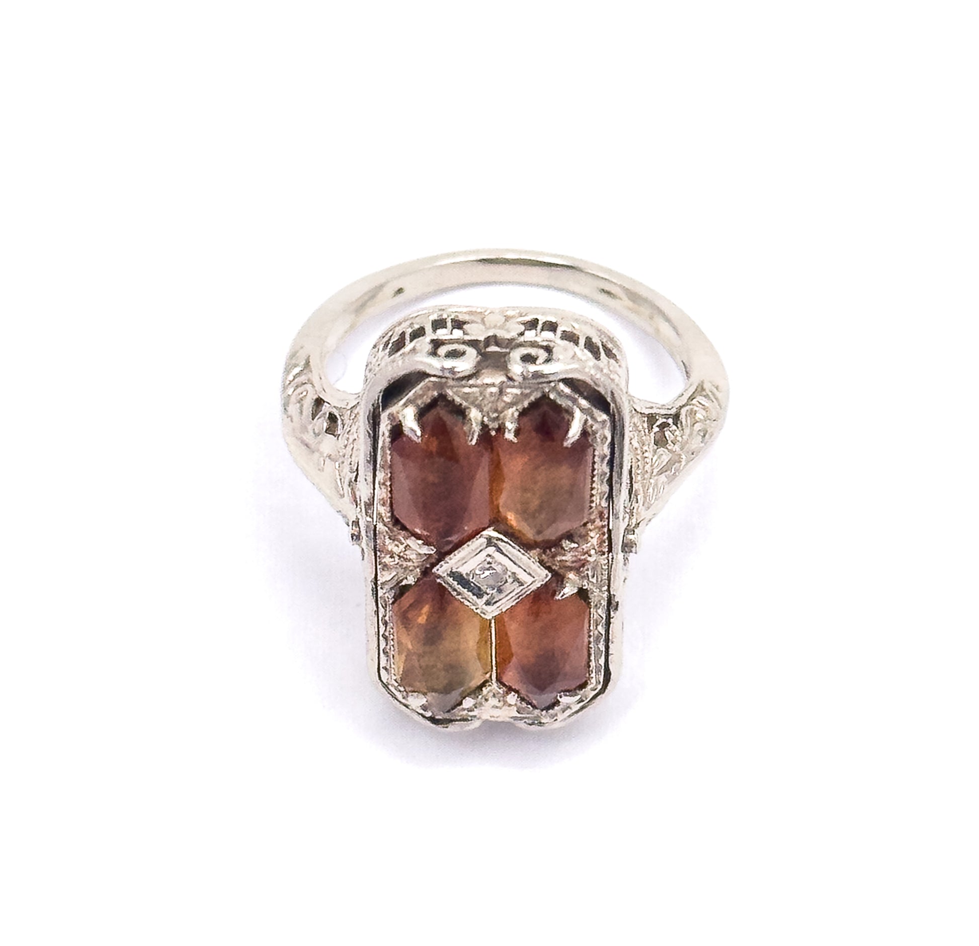 Straight-on view of the citrine side, showing the pierced scrollwork across the top of the gallery, the diamond-shaped centre setting, and the engraved shoulders flowing into the slim shank.