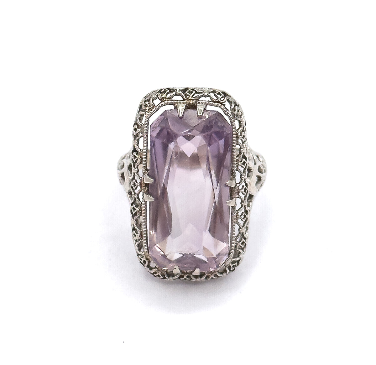 Straight down onto the face, the pastel purple amethyst fills the softly rectangular head with double prongs at each corner and milgrain-edged filigree framing it all around.