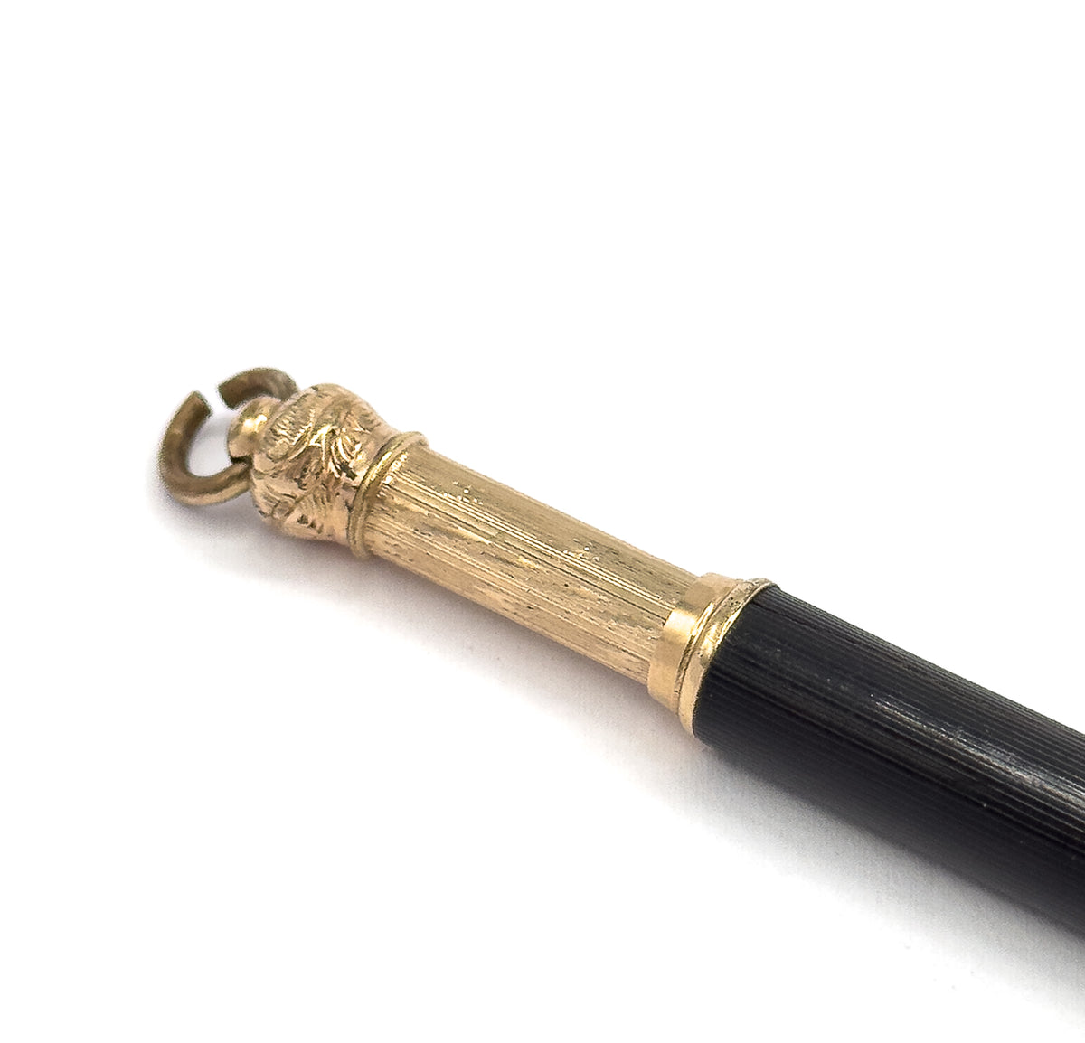 Close view of the gold tone upper end, showing the chased collar, fluted barrel and open suspension ring, with the black textured body angling away.