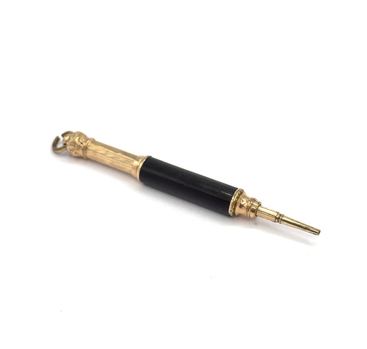 The whole pendant laid flat on white, angled from the suspension ring at upper left down to the tapered gold tone pencil tip extended at lower right.