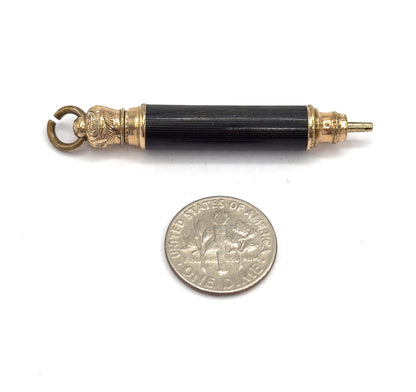 The pendant lying above a dime placed below it on white, the coin showing that the whole barrel is only a little over twice the coin's width.