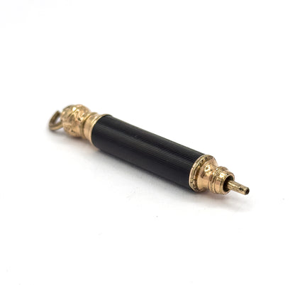 Overhead diagonal view in which the fine lengthwise fluting of the black barrel catches the light along its whole length, with the small suspension ring seen flat at upper left.