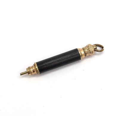 Diagonal view angled the other way, with the tapered tip at lower left and the decorated gold tone collar at upper right, its patterned dome meeting the open suspension ring.