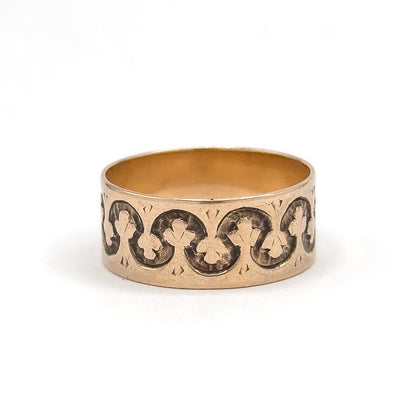 Straight-on centred view with the trefoil links sitting level across the middle of the wide face, smooth rose gold rims running unbroken above and below and the shank opening showing at the top.