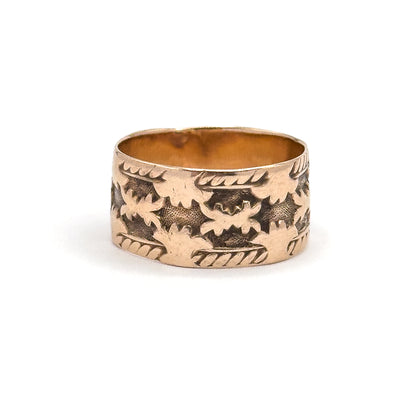 Seen straight on at eye level so the wide face fills the view, the carved leaf pattern centred across the front with a soft shadow beneath on the plain background.