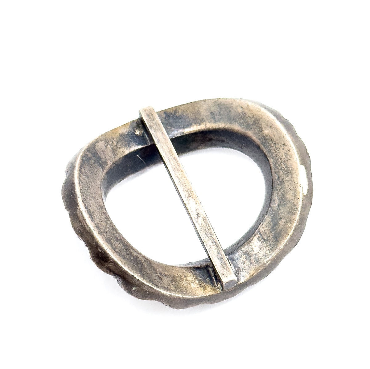 The reverse of the buckle, showing the plain patinated underside of the oval frame and the flat central bar seated in its notches at each side.