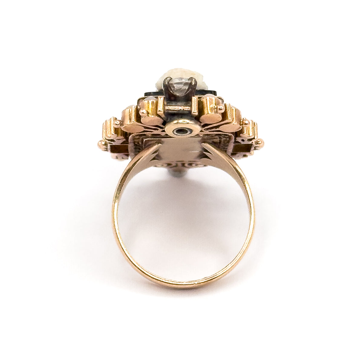 Looking straight through the full circle of the shank from below, the underside of the setting shows its open framework and central round aperture, with the prong-set diamond visible at the very top.
