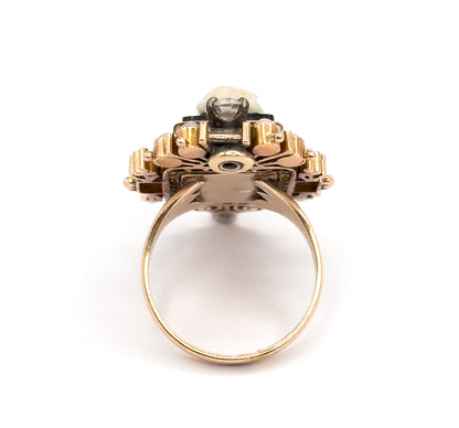 Looking straight through the full circle of the shank from below, the underside of the setting shows its open framework and central round aperture, with the prong-set diamond visible at the very top.