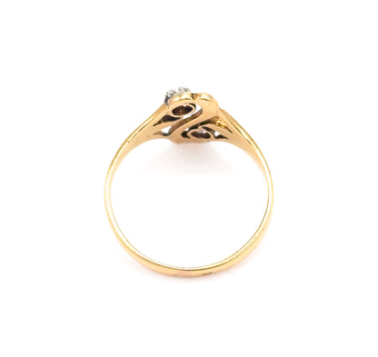 Viewed through the circle of the shank from below, the openwork gallery beneath the white gold "S" face is visible with the two diamonds glimpsed at the top.