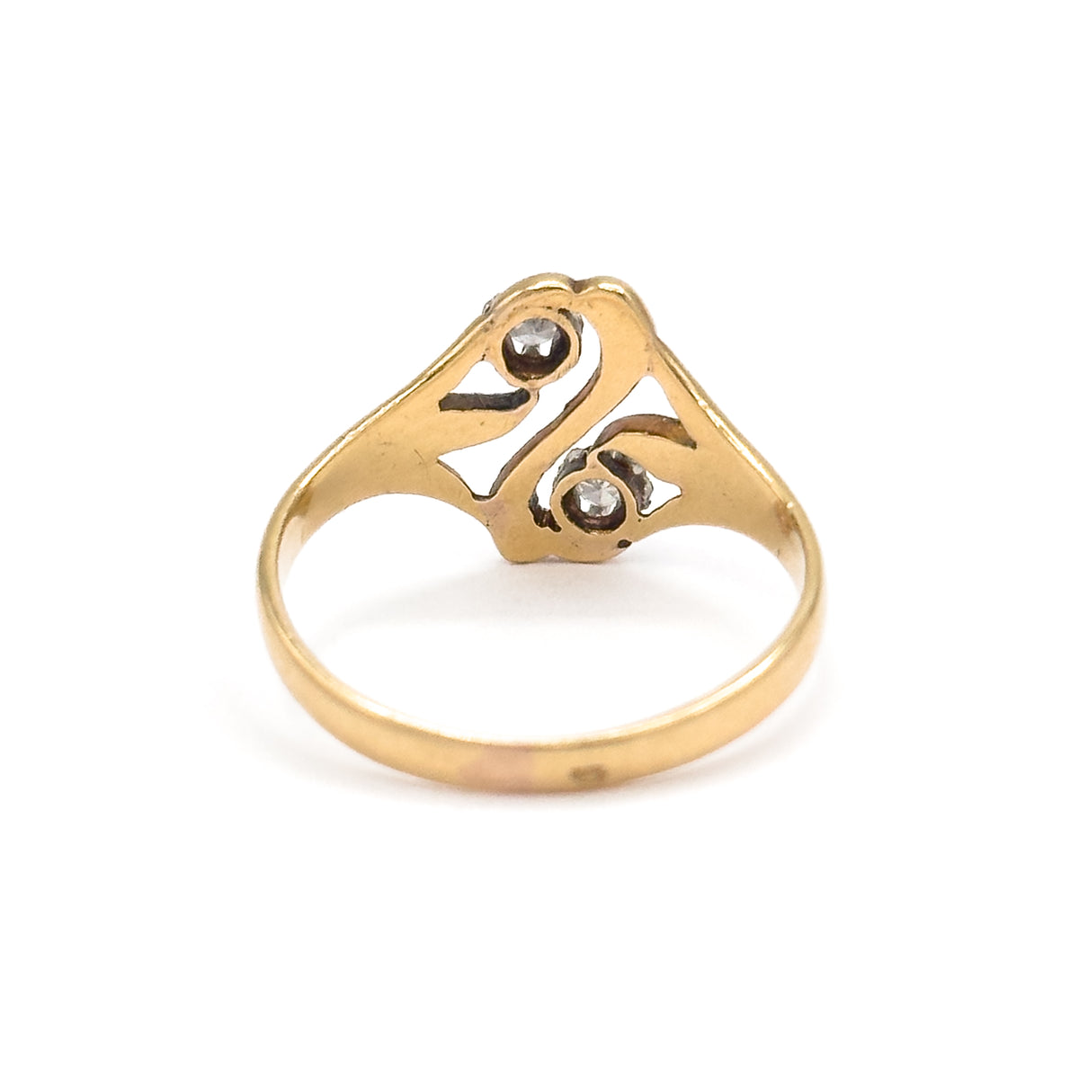 Rear view standing upright on white, the 18K yellow gold shank rising to the back of the openwork "S" face where the two diamonds show through their prong settings.