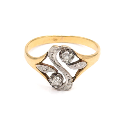 Head-on upright view against white, the full "S" face centred with its two prong-set diamonds set diagonally and milgrain-edged white gold curves flowing between the yellow gold shank.