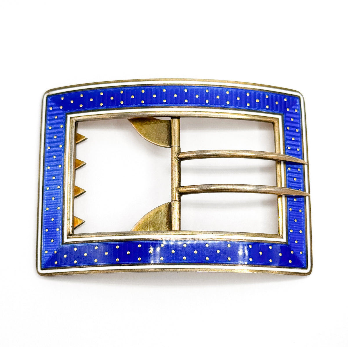 Flat square-on view of the whole buckle against plain white, showing the slight bow of the long edges and the central vertical bar where both curved tongues are hinged.