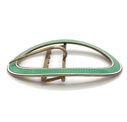 Near eye-level view from the back edge, the oval rim seen almost side-on so the mint green and white enamel band reads as a thin curved line above the prong and crossbar.
