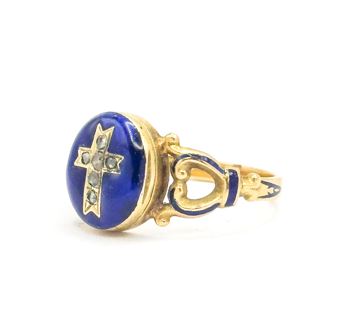 Angled front-left view with the locket closed, the enamel face turned towards the camera while the heart-shaped openwork shoulder and blue enamel band on the right lead back to the tapering shank.