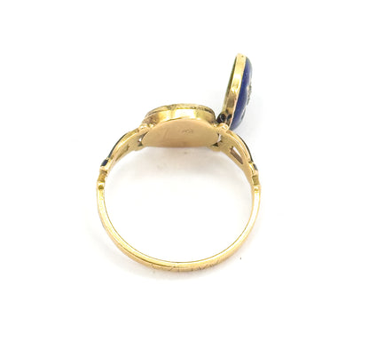 Profile view against white with the hinged face standing open, showing the smooth gold back of the empty compartment, the openwork shoulders and the slim band tapering to a narrow shank.