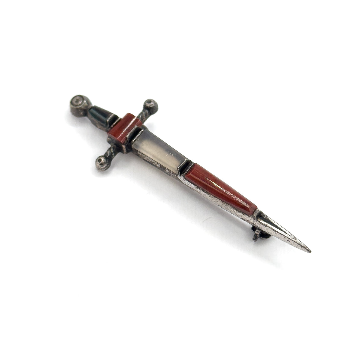 Angled from the point end on white, the reddish-brown and pale grey blade cabochons catching the light while the beaded crossguard and pommel recede behind.
