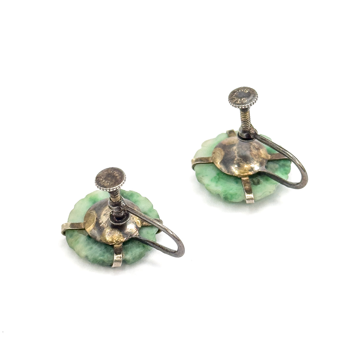 Reverse view of both earrings against white, showing the sterling silver backplates with patina, the curved screw-back arms and the milled discs on each threaded screw post.