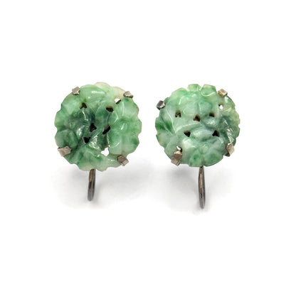 Straight-on front view of both earrings standing upright, the curved screw-back arms hanging clearly below each carved jade disc like small hooks against the plain background.