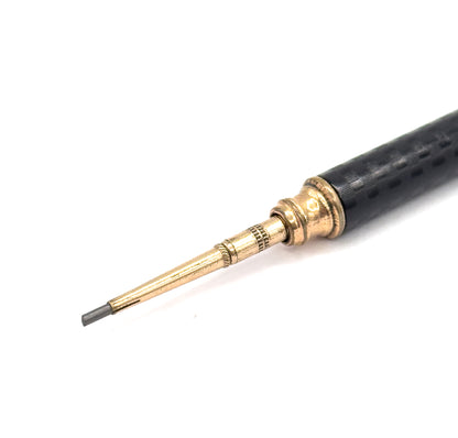 Close crop of the lower end, showing the stepped telescoping gold filled tip with its knurled bands and tapering sleeve, the grey lead point protruding at the very end.