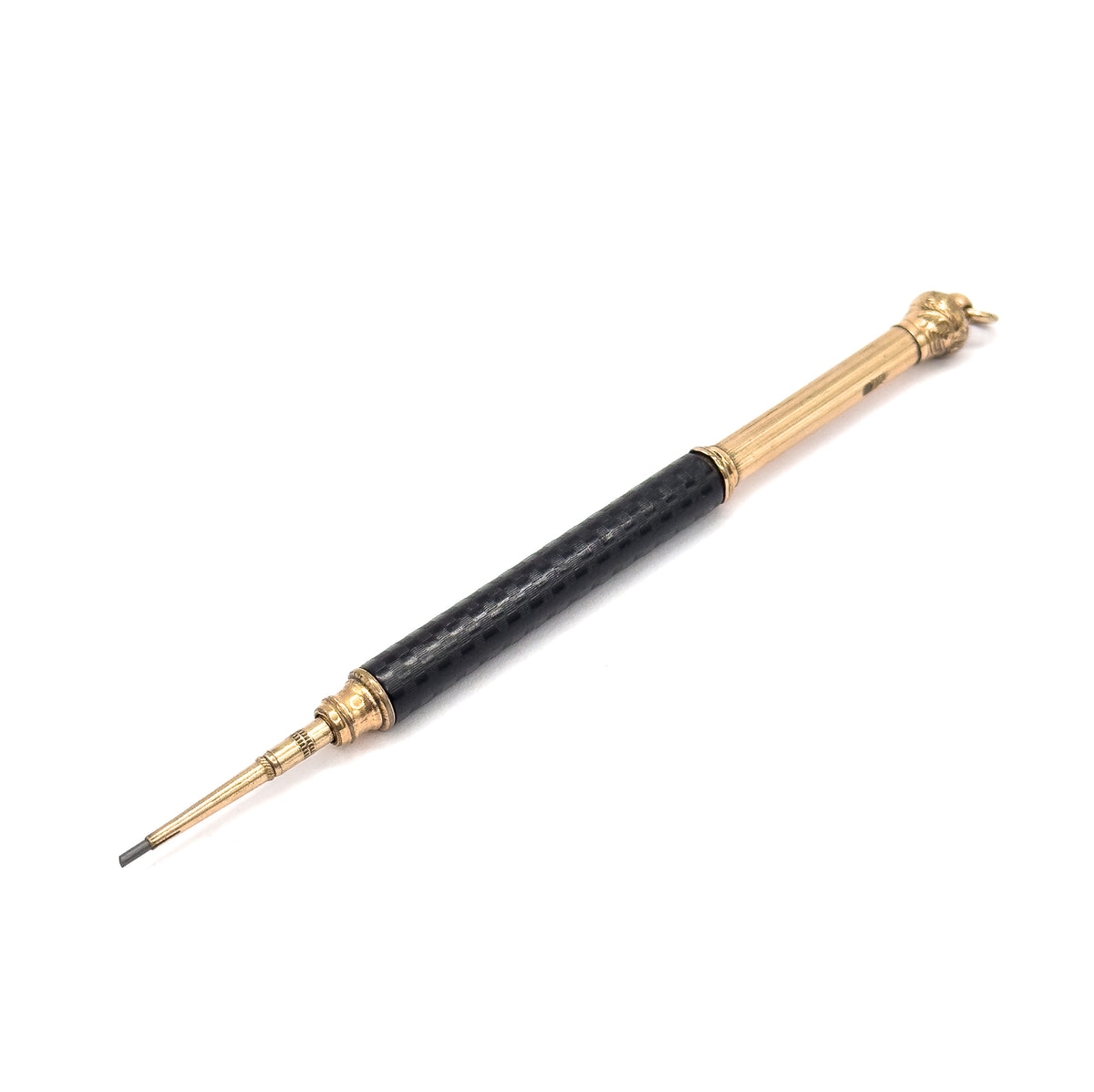 Whole pencil laid diagonally with the cap and jump ring at upper right, showing the full length of the textured black chased rubber barrel between its gold filled collars.