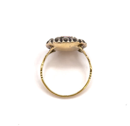 Viewed from behind and above, the closed-back gold underside of the face fills the centre, the diamond halo rising beyond it and the fine shank forming a full circle below.