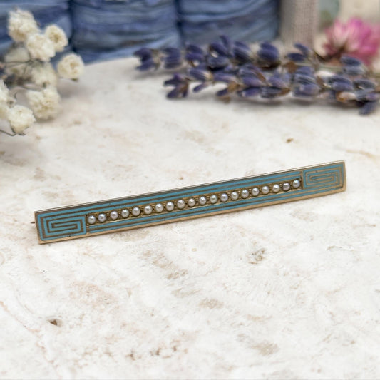 Decorative bar with gemstones on a textured surface with flowers in the background