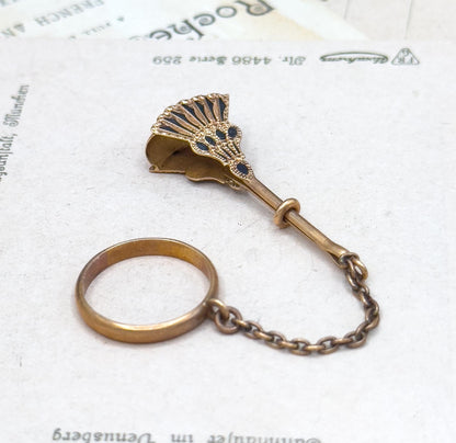Vintage-style bronze magnifying glass with chain on a white background