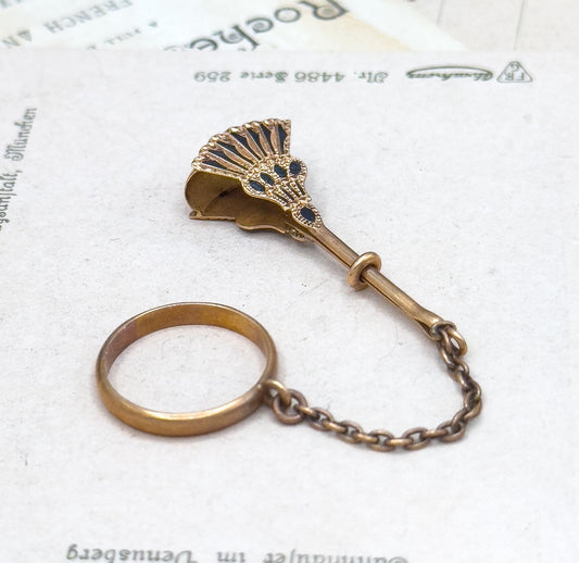 Vintage-style bronze magnifying glass with chain on a white background