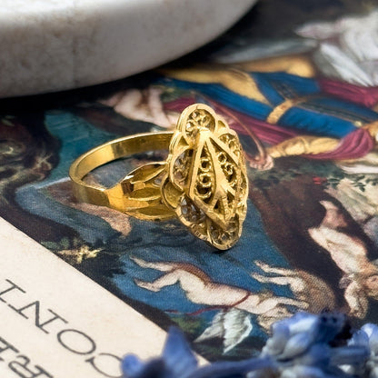 Gold ring on an open book with a tarot card in the background