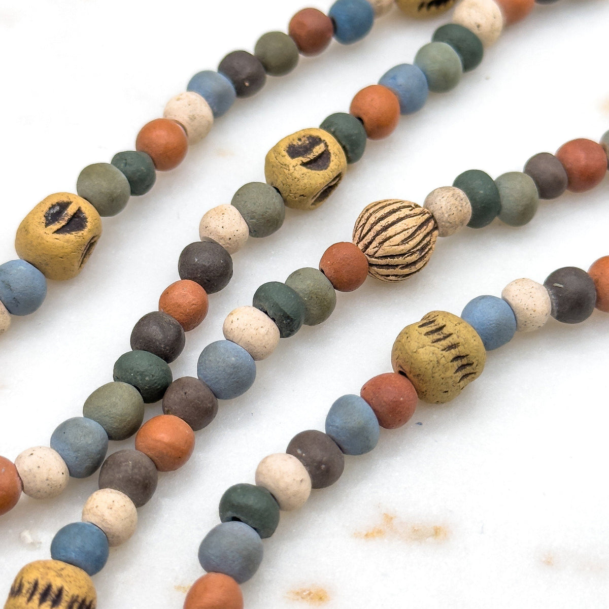 Colorful beaded necklaces on a white background