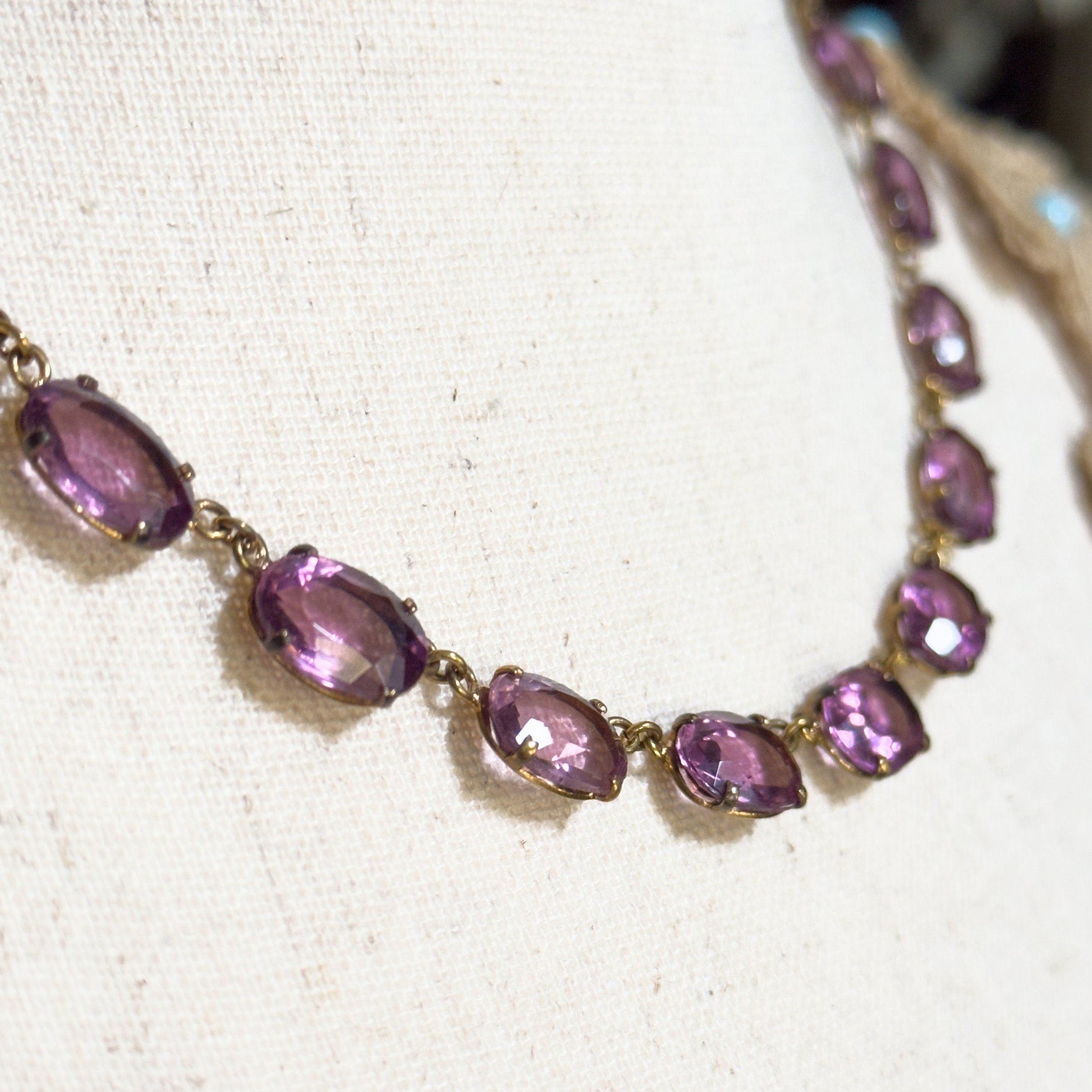 Necklace with purple gemstones on a light background