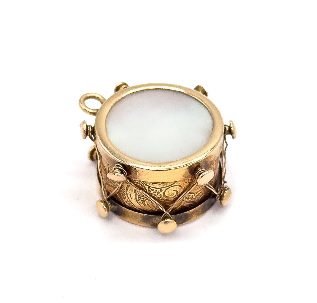 Almost the same view with slightly different angle, rotated so the bail sits at the upper left and the mother of pearl face and engraved side band are seen more from above.