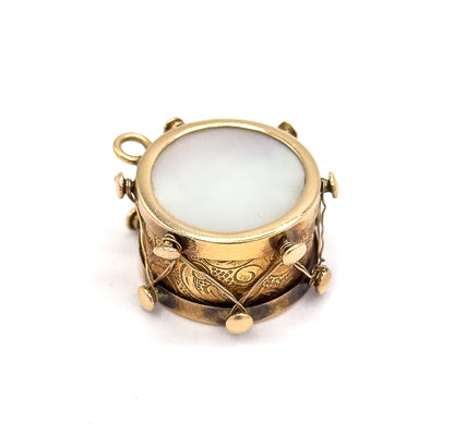 Almost the same view with slightly different angle, rotated so the bail sits at the upper left and the mother of pearl face and engraved side band are seen more from above.