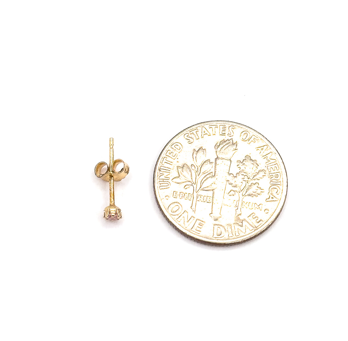 A single stud lies on its side beside a dime, showing the full post, butterfly back and the round pink glass stone in its prongs at a scale the coin makes clear.