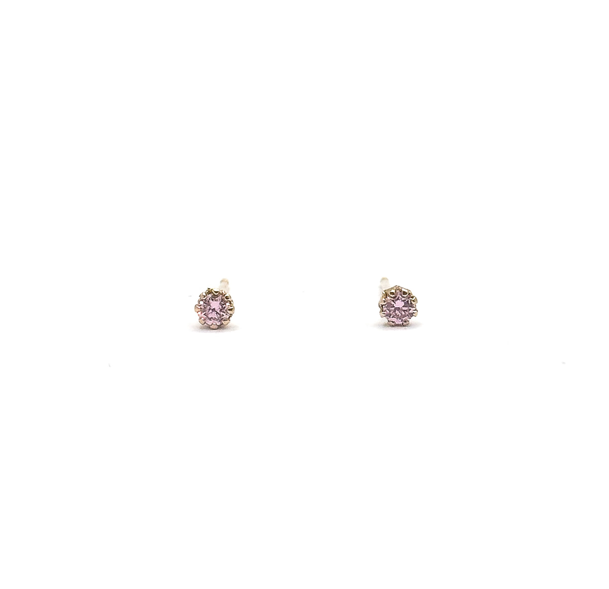 The pair stands upright side by side on a white ground, face-on so each round pink glass stone and its ring of prongs is seen straight from the front.