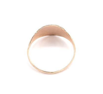Viewed from behind, the underside of the oval face arches over the open circle of the shank, showing how the band narrows to a slim wire at the base.