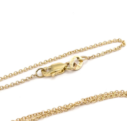 Edwardian aquamarine and seed pearl pendant necklace, shown as a close view of the 14K yellow gold chain's lobster clasp and stamped oval link against a white background.